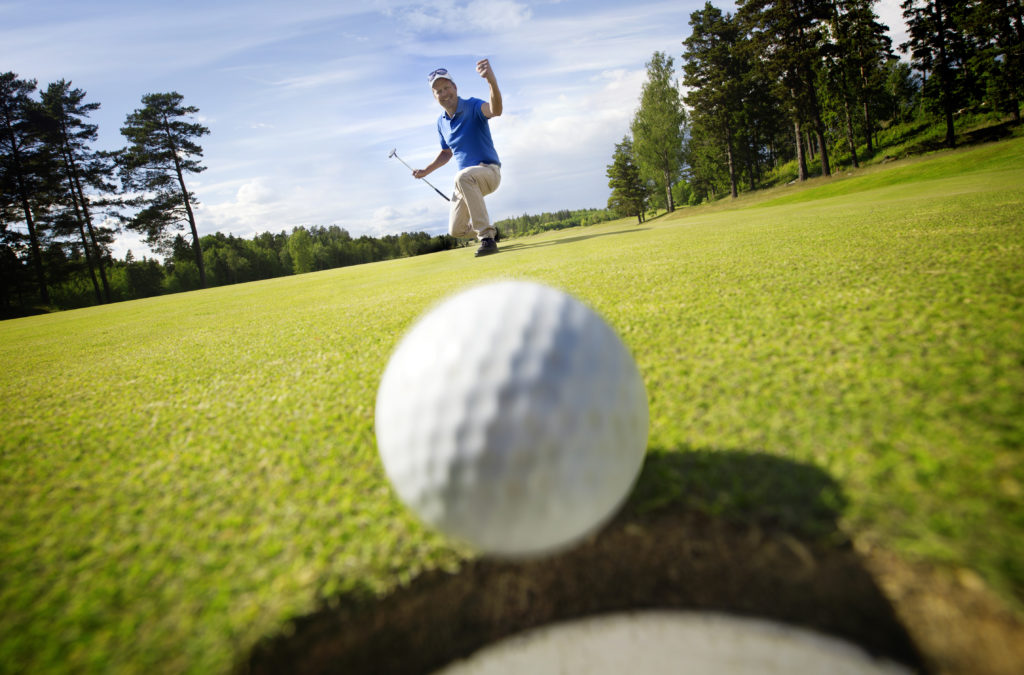 Golfer excited ball in hole