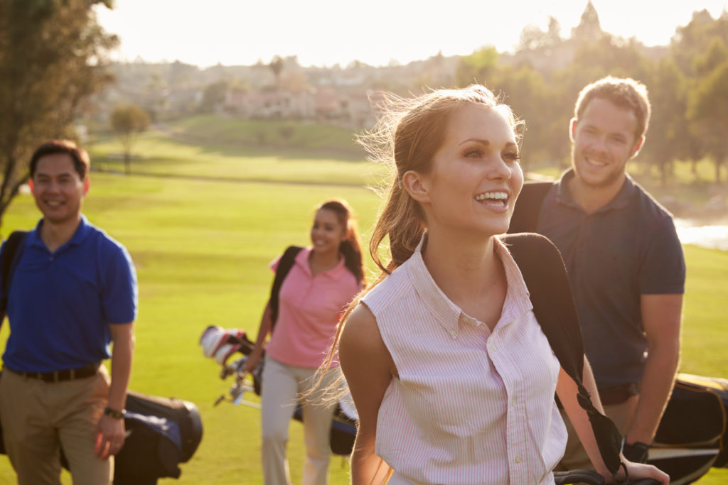 Happy golfers walking