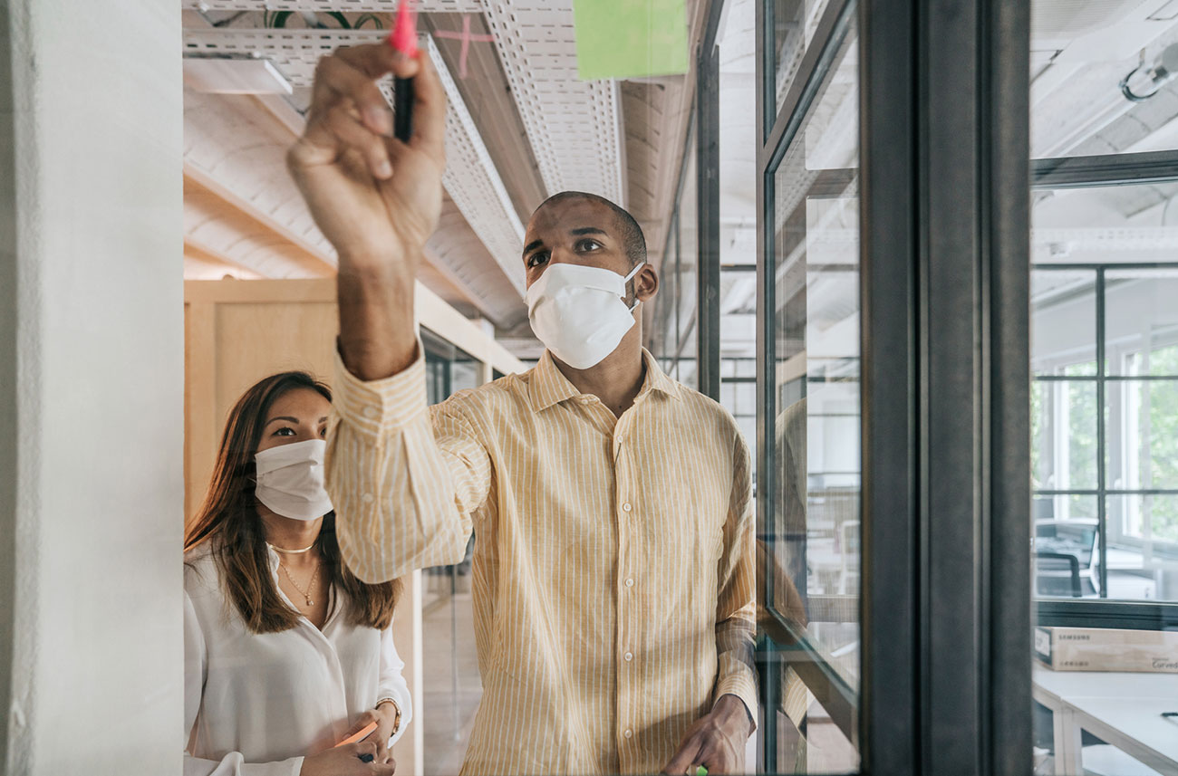 co-workers collaborating and wearing face masks