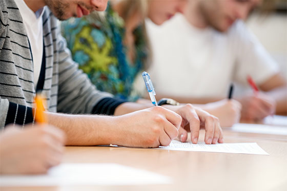 Kids writing on test papers at school