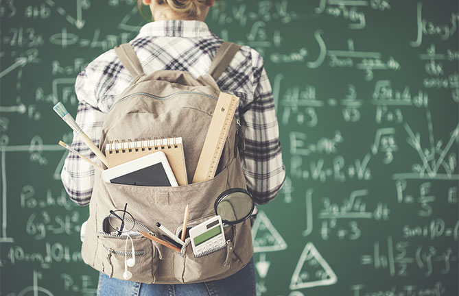 Student wearing backpack full of school supplies