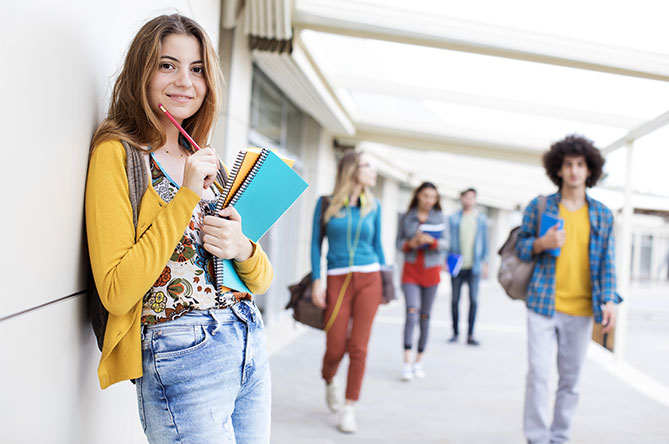 Student at school with notebooks and pencil