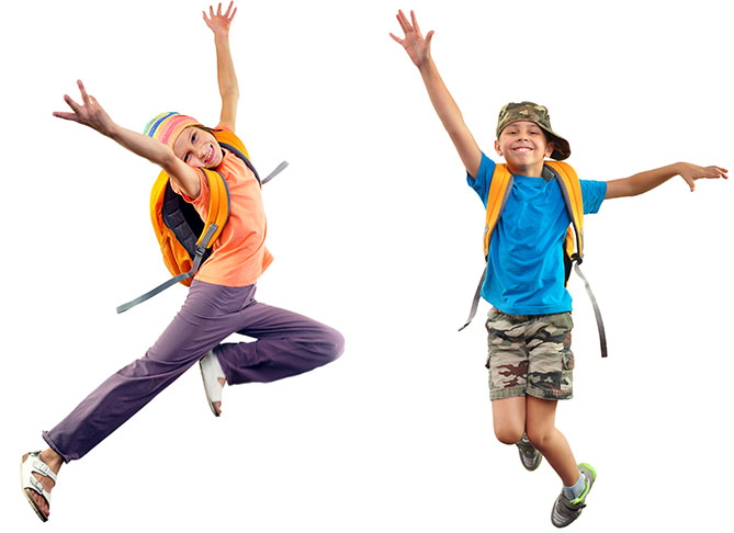 Happy Students wearing backpacks jumping in the air