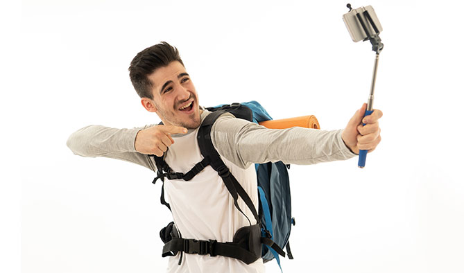 Student wearing backpack taking selfie