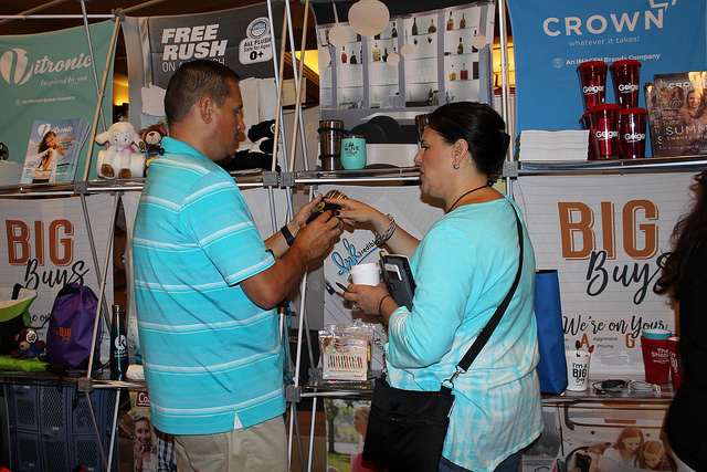 Tradeshow attendants looking at products